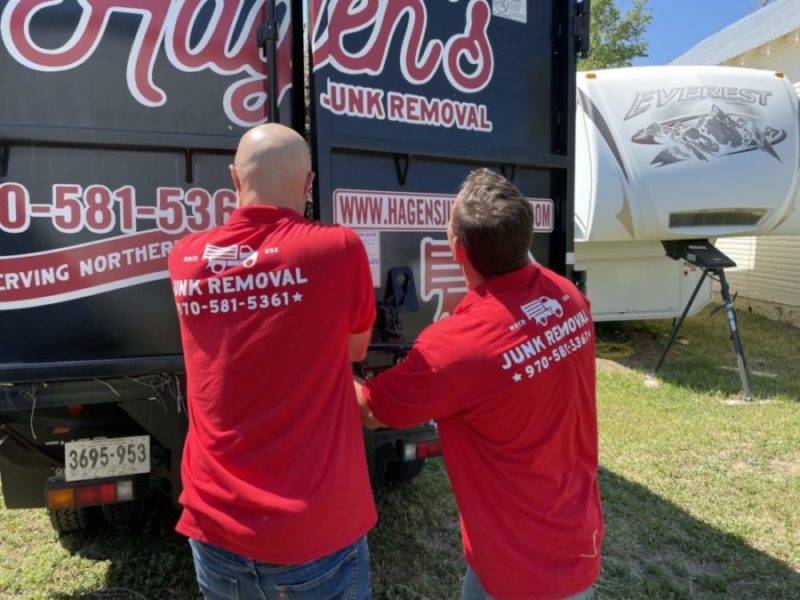 Hagen's Junk removal team closing truck doors after commercial junk removal services