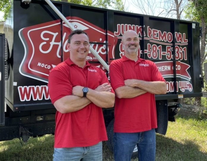 hagens junk removal pros smiling in front of junk removal truck