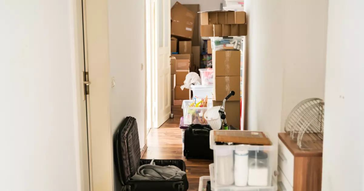 A hallway with boxes and luggage
