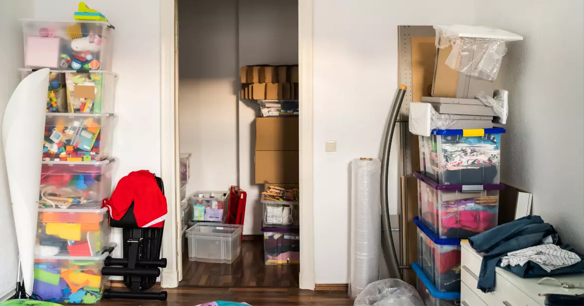 A room with a door open and a pile of boxes
