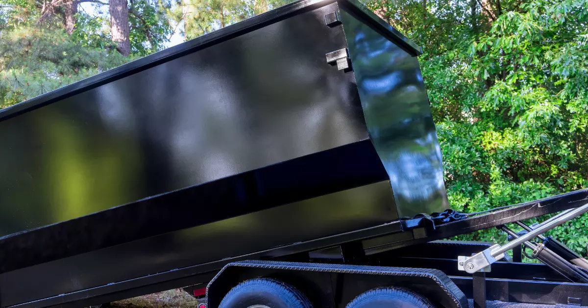 A black dumpster on a trailer