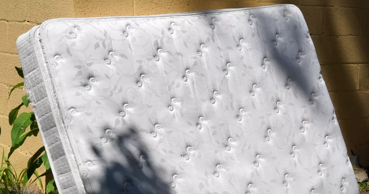 Used mattress left outside awaiting pickup for mattress removal 1